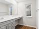 Bright bathroom features quartz counters, wood floors, and large mirror at 20238 Allegheny Ln, Westfield, IN 46074