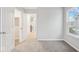 Bright bedroom with gray carpet, closet and view of the outdoors through a window at 20238 Allegheny Ln, Westfield, IN 46074
