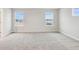 Bright bedroom with neutral walls, carpet and two windows with view of neighborhood at 20238 Allegheny Ln, Westfield, IN 46074