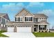 Two-story home with a three-car garage, brick accents, manicured lawn, and a welcoming front entrance at 20238 Allegheny Ln, Westfield, IN 46074
