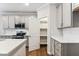 Modern kitchen featuring ample cabinet space, stainless steel appliances, and a convenient pantry at 20238 Allegheny Ln, Westfield, IN 46074