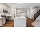 Well-appointed kitchen with stainless steel appliances, a large island, and adjacent access to the staircase at 20238 Allegheny Ln, Westfield, IN 46074