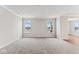 Spacious living room with neutral gray walls, plush carpeting, and plenty of natural light from two large windows at 20238 Allegheny Ln, Westfield, IN 46074