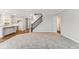 Open living area showcasing a modern kitchen, staircase, and comfortable carpeting for a seamless transition at 20238 Allegheny Ln, Westfield, IN 46074