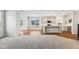 Open-concept living space with a view of the kitchen, featuring hardwood floors and neutral paint colors at 20238 Allegheny Ln, Westfield, IN 46074