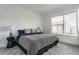 Relaxing bedroom features neutral tones, a comfortable bed, and ample natural light from a large window at 2115 Coretta Way, Indianapolis, IN 46202