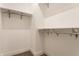 Bright walk-in closet boasts ample storage with shelving and metal hanging rods at 2115 Coretta Way, Indianapolis, IN 46202