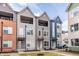 Contemporary townhomes with balconies and colorful facades create inviting curb appeal at 2115 Coretta Way, Indianapolis, IN 46202