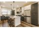 Stylish kitchen boasts two-tone cabinets, stainless steel appliances, and a spacious island with seating at 2115 Coretta Way, Indianapolis, IN 46202
