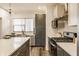 Well-equipped kitchen with gray cabinetry, stainless steel appliances, and quartz countertops providing ample workspace at 2115 Coretta Way, Indianapolis, IN 46202