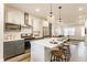 Open kitchen overlooking the living area, complete with breakfast bar and stainless steel appliances at 2115 Coretta Way, Indianapolis, IN 46202