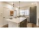 Kitchen island featuring quartz countertop with modern lighting and gray cabinetry at 2115 Coretta Way, Indianapolis, IN 46202