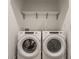 Convenient laundry room featuring a modern washer and dryer with overhead shelving at 2115 Coretta Way, Indianapolis, IN 46202