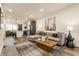 Inviting living area with gray sectional, stylish rug, and contemporary artwork creating a comfortable ambiance at 2115 Coretta Way, Indianapolis, IN 46202
