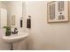 Stylish powder room boasts a vessel sink, sleek faucet, and eye-catching decor at 2115 Coretta Way, Indianapolis, IN 46202