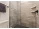 This walk-in shower features a black shower head, mosaic tile floor, and two convenient corner shelves at 2115 Coretta Way, Indianapolis, IN 46202