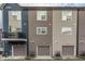 Street view displays townhomes with modern facades, balconies, and convenient attached garages at 2115 Coretta Way, Indianapolis, IN 46202