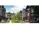 A charming townhouse community courtyard featuring colorful exteriors, landscaped gardens, and inviting walkways at 2139 Coretta Way, Indianapolis, IN 46202