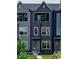 Charming three-story townhouse featuring a private balcony, modern facade, and inviting entrance at 2139 Coretta Way, Indianapolis, IN 46202