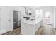 Bright kitchen features stainless appliances, white cabinets, and a spacious island at 2139 Coretta Way, Indianapolis, IN 46202