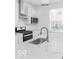 Bright kitchen with stainless appliances, white cabinets, and elegant countertop detail at 2139 Coretta Way, Indianapolis, IN 46202