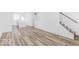 Bright, open space featuring laminate flooring, stairs, and a view of the kitchen at 2139 Coretta Way, Indianapolis, IN 46202