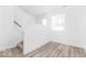 Open-concept living space with stairs, laminate flooring, and abundant natural light at 2139 Coretta Way, Indianapolis, IN 46202