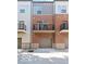 View of a modern townhouse featuring brick and siding with a private balcony and an attached garage at 2139 Coretta Way, Indianapolis, IN 46202