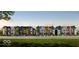 A street view of newly built colorful townhouses with well-maintained lawns and beautiful landscaping in a suburban setting at 2139 Coretta Way, Indianapolis, IN 46202