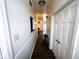 Hallway with white walls and doors, contrasting the dark wood vinyl flooring at 321 N Elder N Ave, Indianapolis, IN 46222