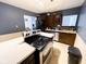 Bright kitchen featuring dark appliances, light countertop, and wood-paneled walls at 321 N Elder N Ave, Indianapolis, IN 46222
