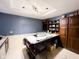 Well-lit kitchen with dark wood cabinets and a central island with chairs at 321 N Elder N Ave, Indianapolis, IN 46222