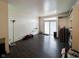 Spacious living room featuring a sliding glass door, dark floors, and a convenient built-in shelving unit at 321 N Elder N Ave, Indianapolis, IN 46222
