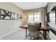 Modern home office with wood-look accent wall, desk, and a view overlooking the outdoors at 4406 Mendocino Blvd, Indianapolis, IN 46075
