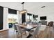 Modern dining area seamlessly blending with the living room, kitchen, and outdoor views at 4424 Mendocino Blvd, Indianapolis, IN 46239