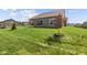 Exterior view showcasing a spacious backyard, lush greenery, and the home's modern architecture at 5040 Carmine St, Brownsburg, IN 46112
