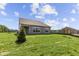 Exterior view displaying a well-maintained lawn, contemporary siding, and ample backyard space at 5040 Carmine St, Brownsburg, IN 46112