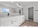 Bright bathroom with double vanity, walk-in closet, large mirror and modern lighting fixtures at 5040 Carmine St, Brownsburg, IN 46112