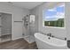 Elegant bathroom featuring a modern shower with glass enclosure and a stylish freestanding bathtub at 5040 Carmine St, Brownsburg, IN 46112