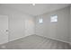 Inviting bedroom featuring neutral walls, carpet, and multiple windows letting in natural light at 5040 Carmine St, Brownsburg, IN 46112