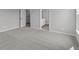 This is a carpeted bedroom with laundry and bathroom entrances at 5040 Carmine St, Brownsburg, IN 46112