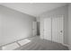 Bedroom featuring neutral carpet, a closet with sliding doors, and an adjoining bathroom at 5040 Carmine St, Brownsburg, IN 46112