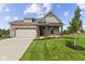 Charming single-story home with brick facade, attached garage, and manicured lawn at 5040 Carmine St, Brownsburg, IN 46112