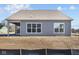 Rear exterior shows covered patio and large windows providing natural light at 5040 Carmine St, Brownsburg, IN 46112