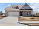 Charming, single-story home with a gray brick facade, attached garage, and well-manicured lawn at 5040 Carmine St, Brownsburg, IN 46112