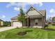 Charming single-story home with brick facade, attached garage, and manicured lawn at 5040 Carmine St, Brownsburg, IN 46112