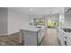 Bright kitchen with white cabinets and countertops offering a seamless transition to the backyard at 5040 Carmine St, Brownsburg, IN 46112