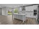 Open kitchen with white cabinets, stainless appliances, and a view of the backyard at 5040 Carmine St, Brownsburg, IN 46112