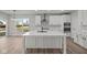 Bright kitchen features a large island, stainless steel appliances, and modern white cabinetry at 5040 Carmine St, Brownsburg, IN 46112