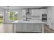Bright kitchen featuring all white cabinets, countertops, and a large center island at 5040 Carmine St, Brownsburg, IN 46112